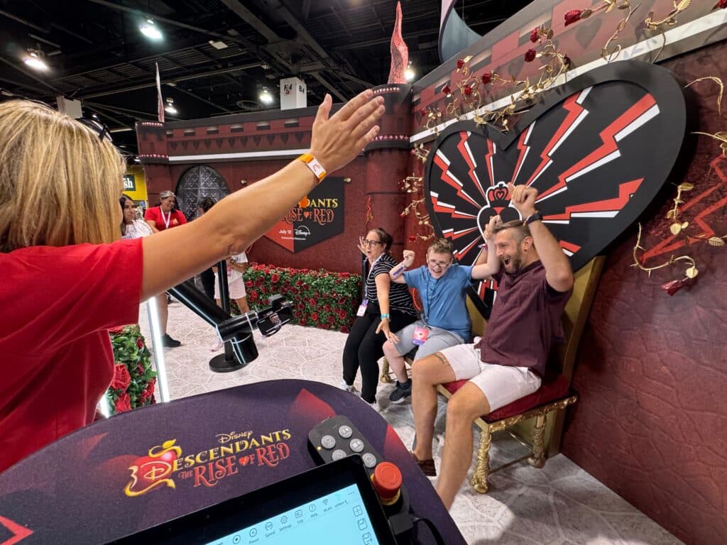 People sitting at the queens throne while dancing for the Glambot Video