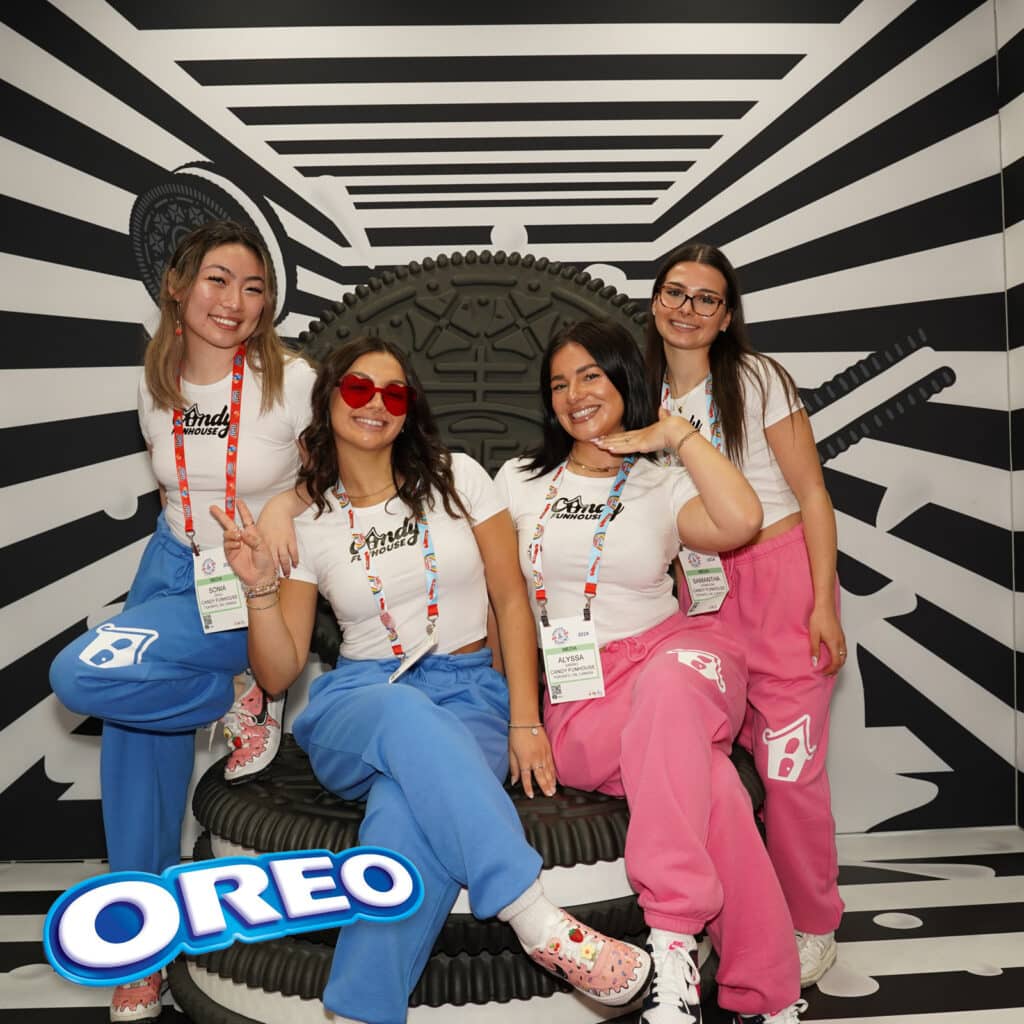 Four ladies sitting on a big oreo seat