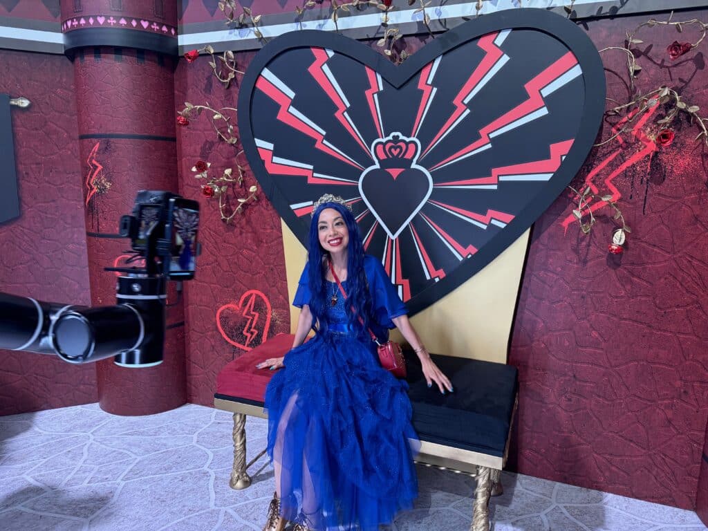 Lady in a vlue dress in front of the Glambot at D23