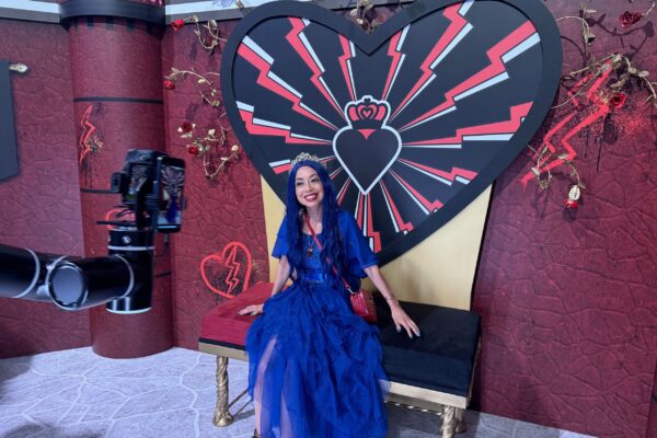 Lady in a vlue dress in front of the Glambot at D23