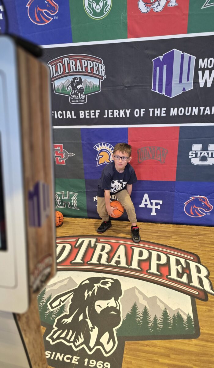 Kid Posing Cool MW Kid posing with a basketball at the Mountain West Basketball Tournament 2025