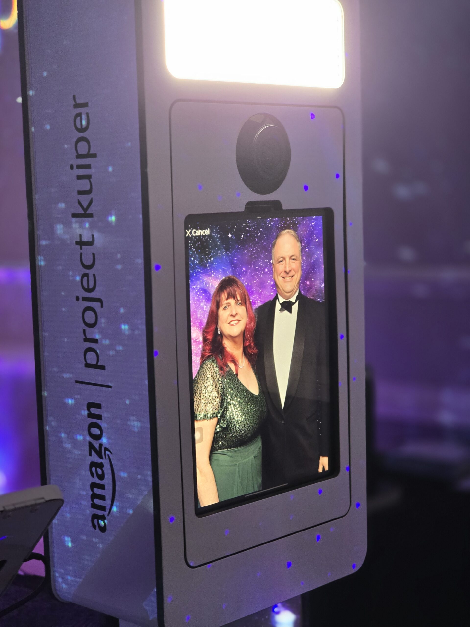 AI photo booth screen showing the photo of a couple at the Amazon Project Kuiper event