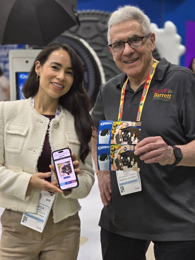 A lady and a gentleman showing their photos at the sweets and snacks expo 2025