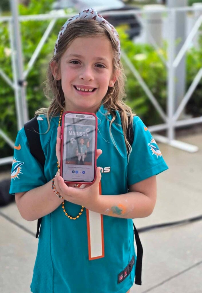 A Miami Dolphins fan holding her AI Picture