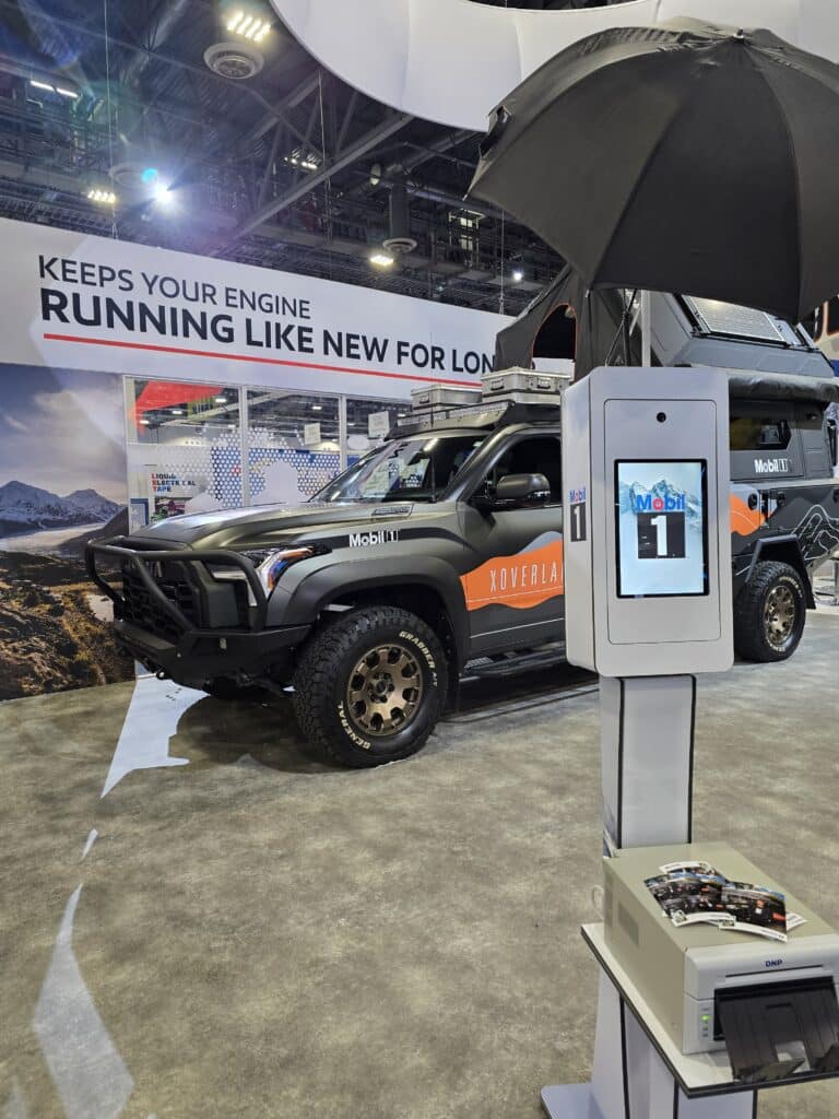Picure of the Photo Booth in front of Mobil 1 Truck at AAPEX 2025