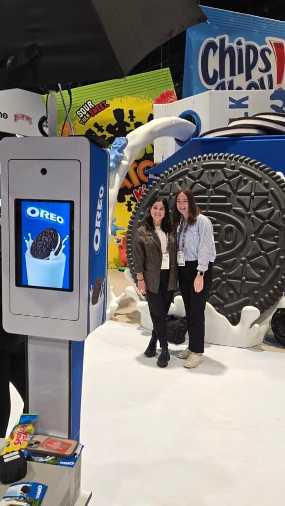 Two ldies taking a picture in front o the Oreo photo Booth