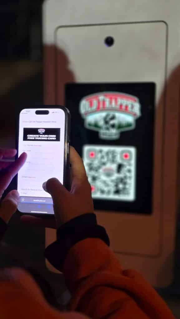 A person sacnning the QR code to fill out the form