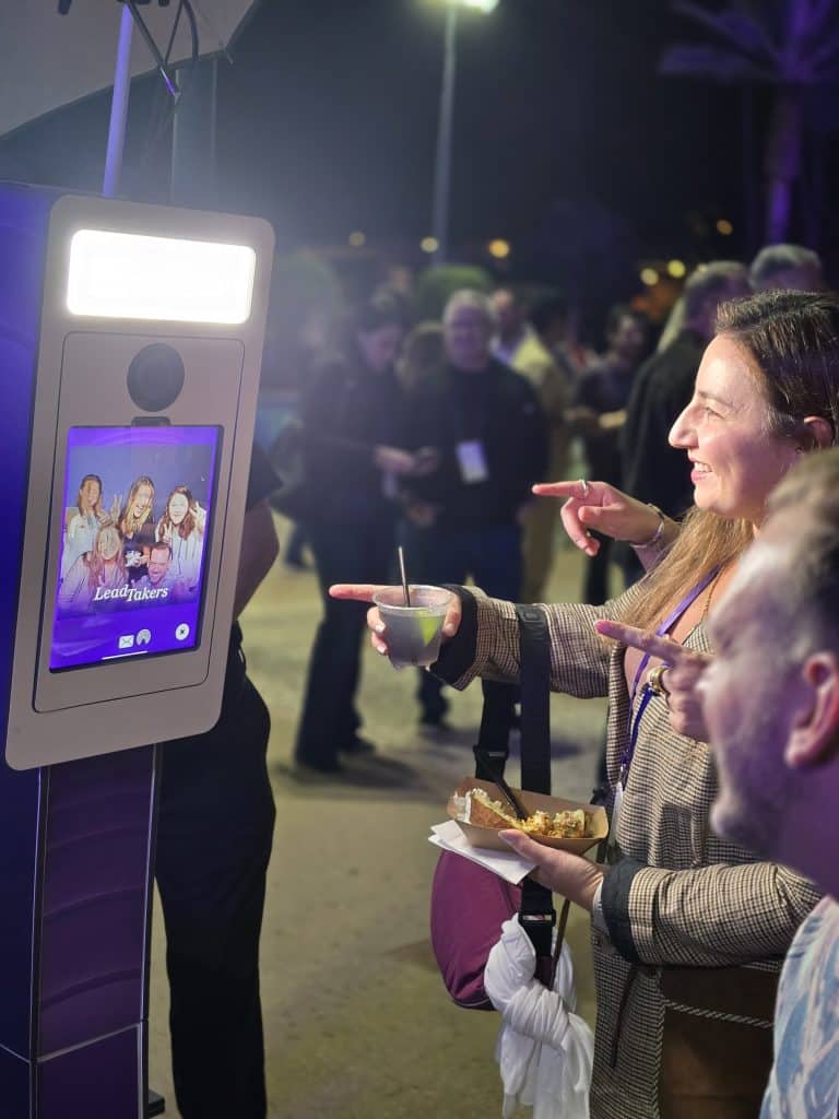 Group of people looking at heir picture taken by the Photo Booth