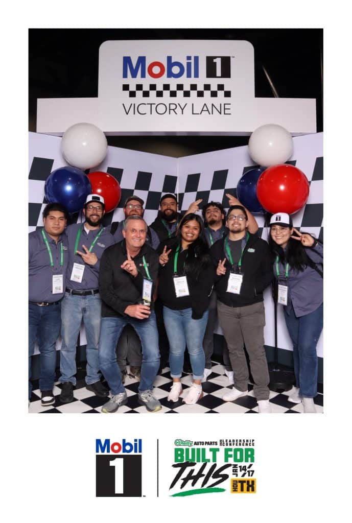 Nig group of people taking a photo at the Mobil 1 finish line
