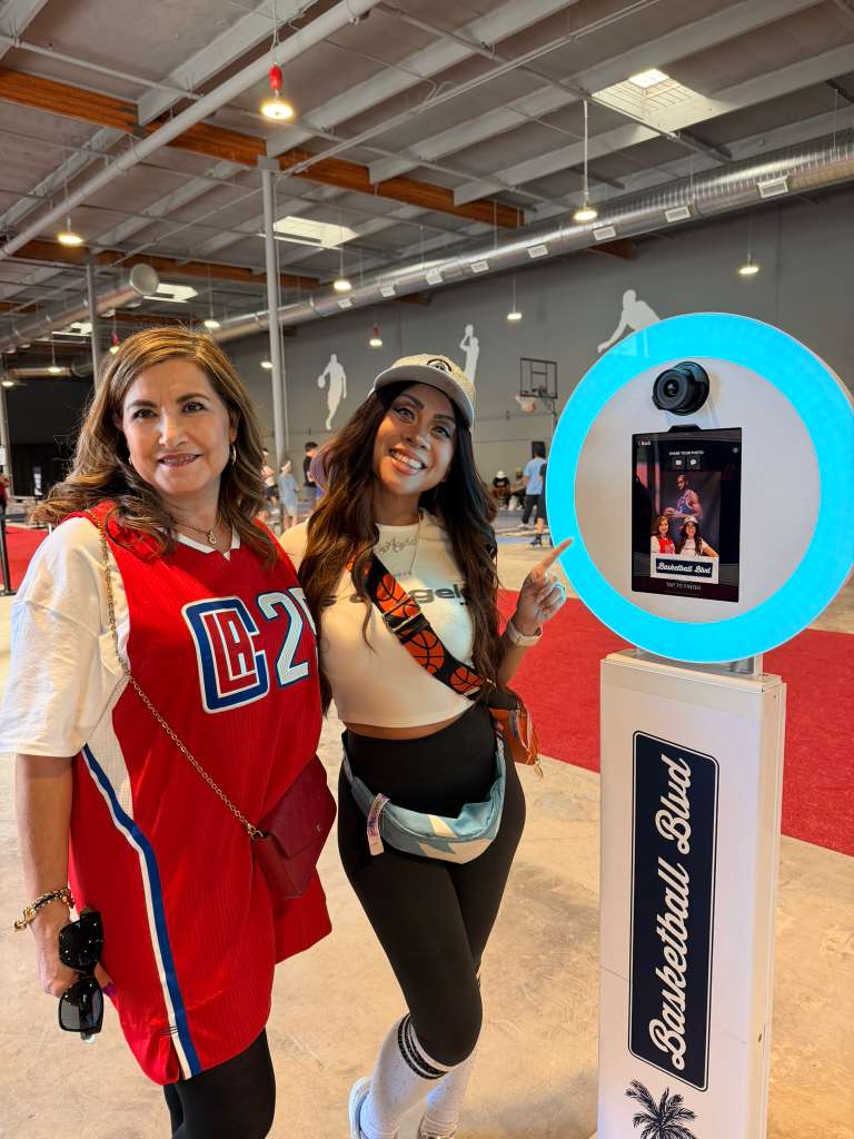Two ladies standing next to the LA Clippers Selfie Booth at NBA All Star 2026