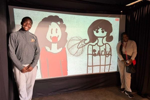 A couple who painted themselves at the Digital Graffiti Wall