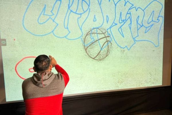 Someone painting on the graffiti wall at NBA All Stars 2026
