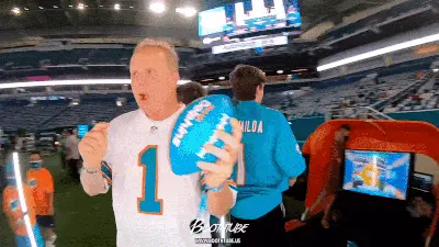 Miami Dolphins fans inside the 360 Photo Booth surrounded by lights creating amazing moments