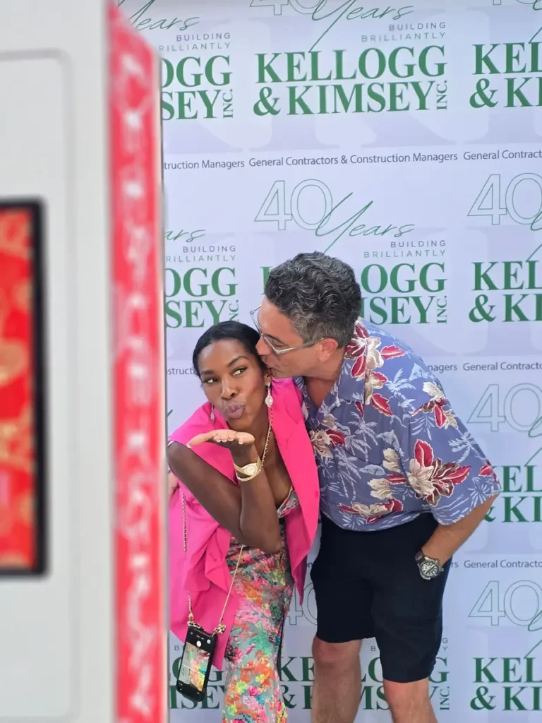 kelloggkimsey Photo (4) A couple taking a picture in front of Kellogg & Kimsey’s Photo Booth