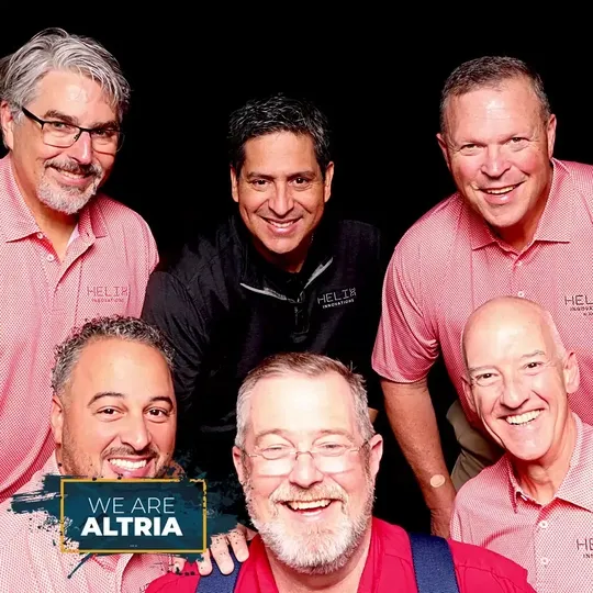 Group of 6 men taking different pictures at the Altria Group Reunion Photo Booth