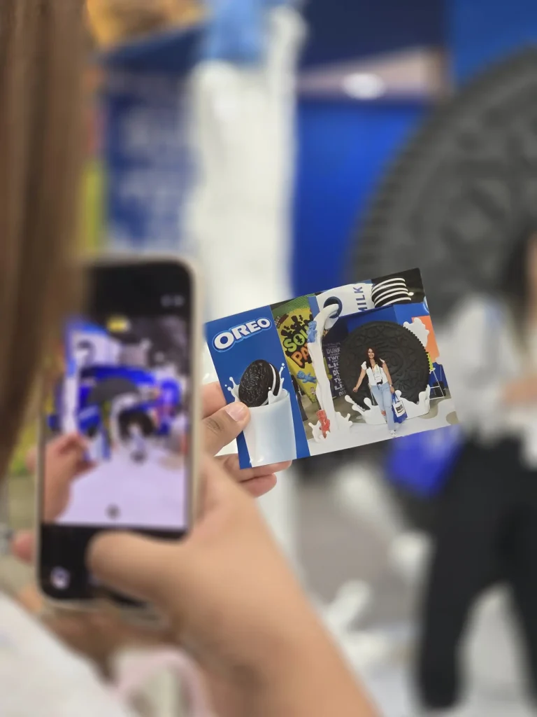 A person taking a picture of their photo priny of the Sweets and snacks expo 2026 to post it on social media