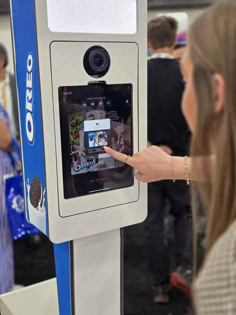 A lady printing her photo at the Sweets and snacks expo 2026 Oreo Photo booth